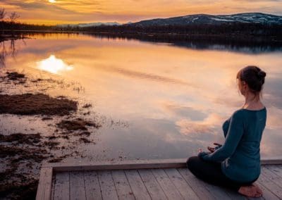 Meditating by a mountain lake Venabu Fjellhotell