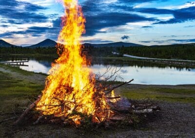 Midsummer bonfire by mountain lake