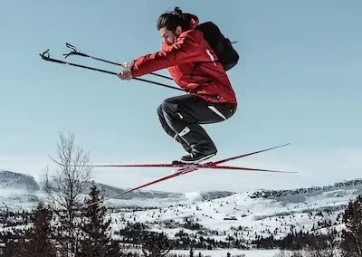 Cross country skier jumps off the snow