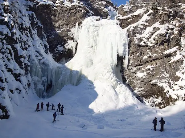 Group of snowshoers and an icefall