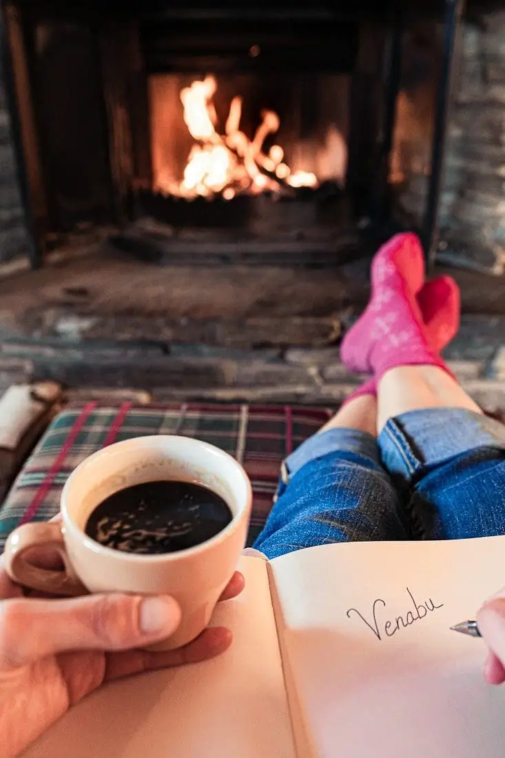 Sitting next to warm fire with a coffee